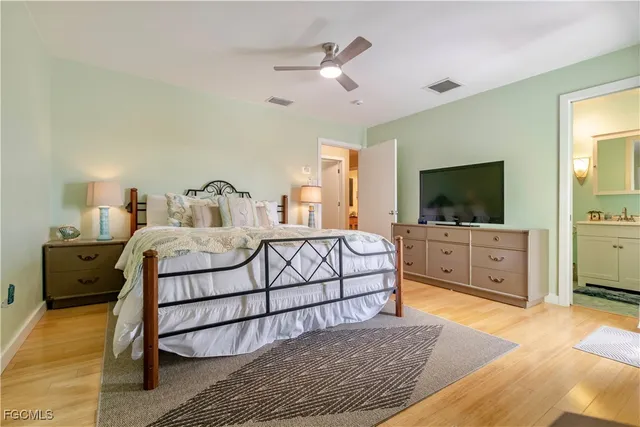 a bedroom with a bed and glass door