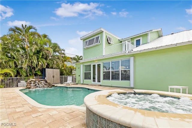 a swimming pool with outdoor seating and yard