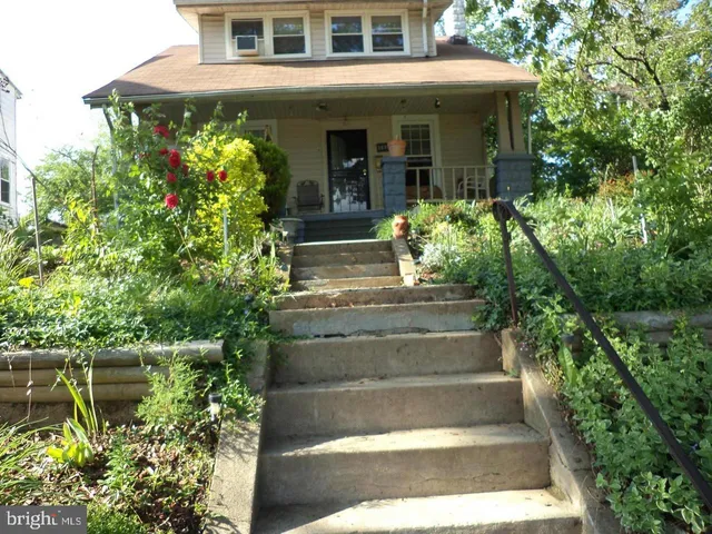 a view of a house with potted plants