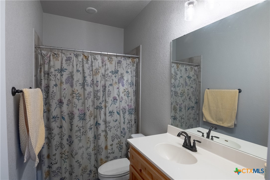 7909 McCulloch Road Temple, TX 76502 - Photo 14 of 46 a bathroom with a sink toilet and shower