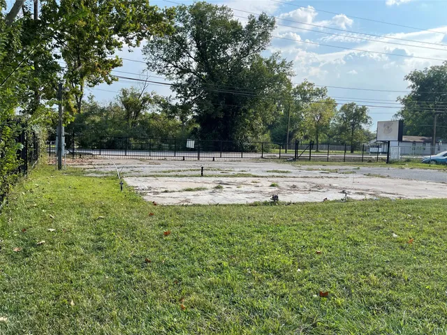 a view of a swimming pool and a yard