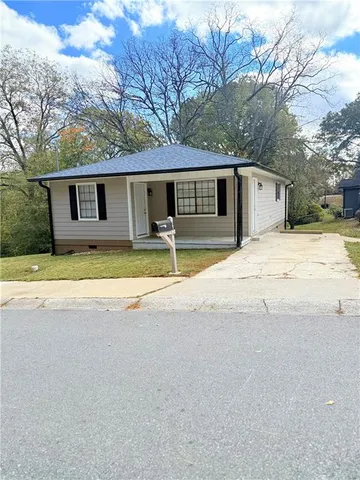 a house that has a tree in front of it