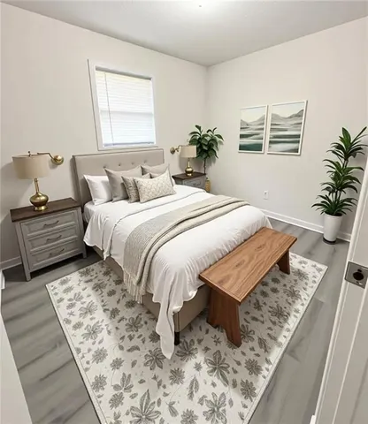 a bed sitting in a bedroom next to a window