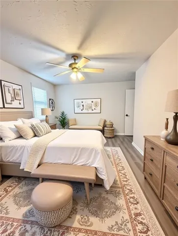 a spacious bedroom with a bed and a chandelier