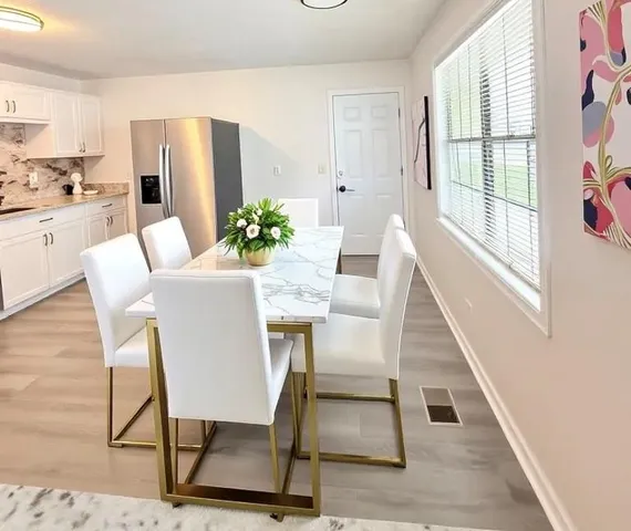 a view of a dining room with furniture and a potted plant
