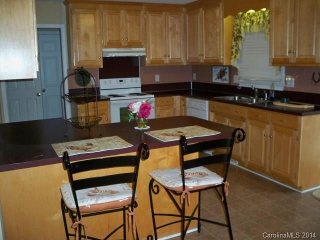 1850 George Brown Road Crouse, NC 28033 - Photo 7 of 23 a kitchen with a chair a stove and a microwave