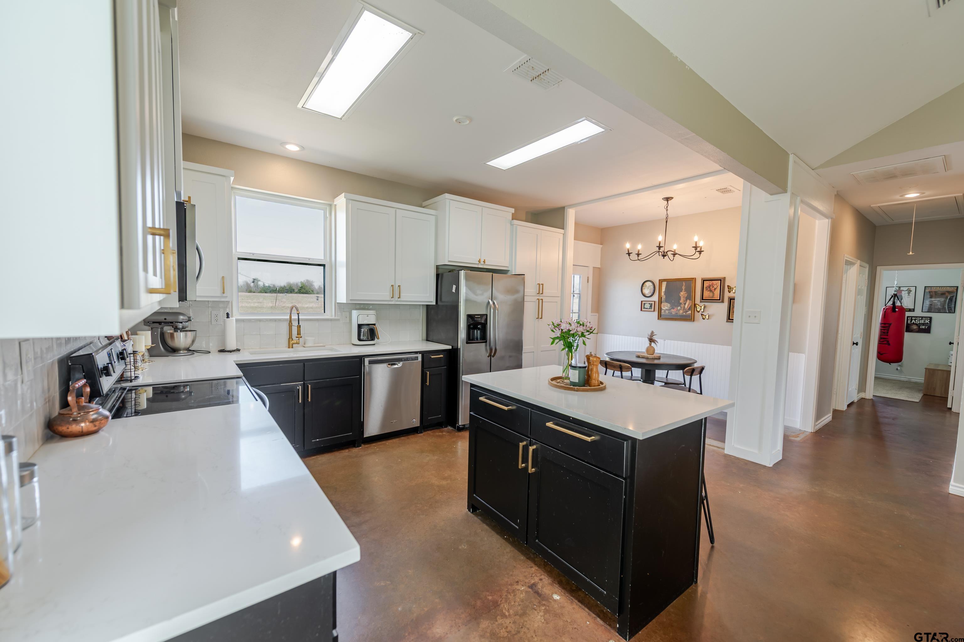 130 County Rd NW 1019 Mount Vernon, TX 75457 - Photo 11 of 17 a kitchen with a sink a counter top space a stove and cabinets