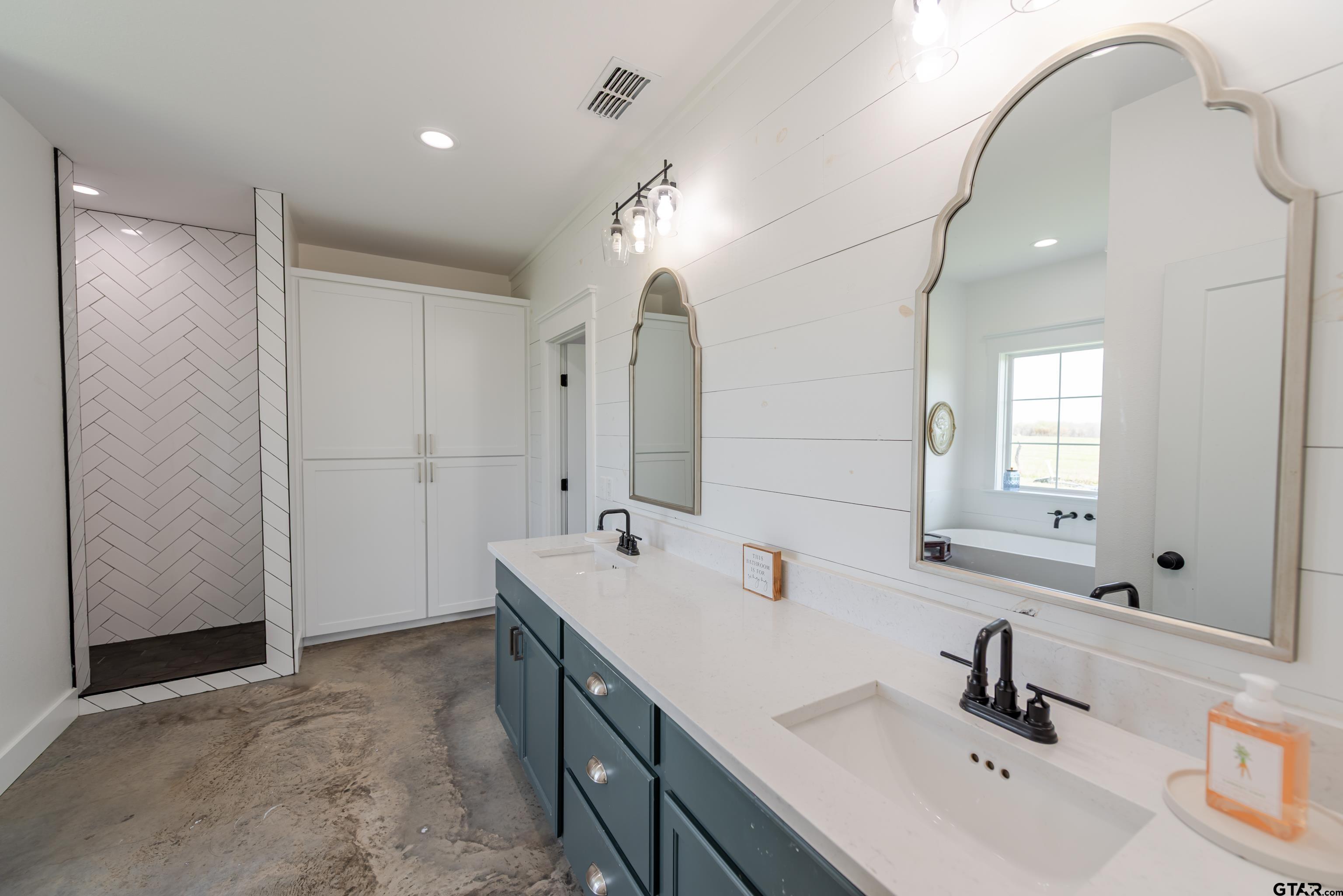 130 County Rd NW 1019 Mount Vernon, TX 75457 - Photo 6 of 17 a bathroom with a double vanity sink mirror and