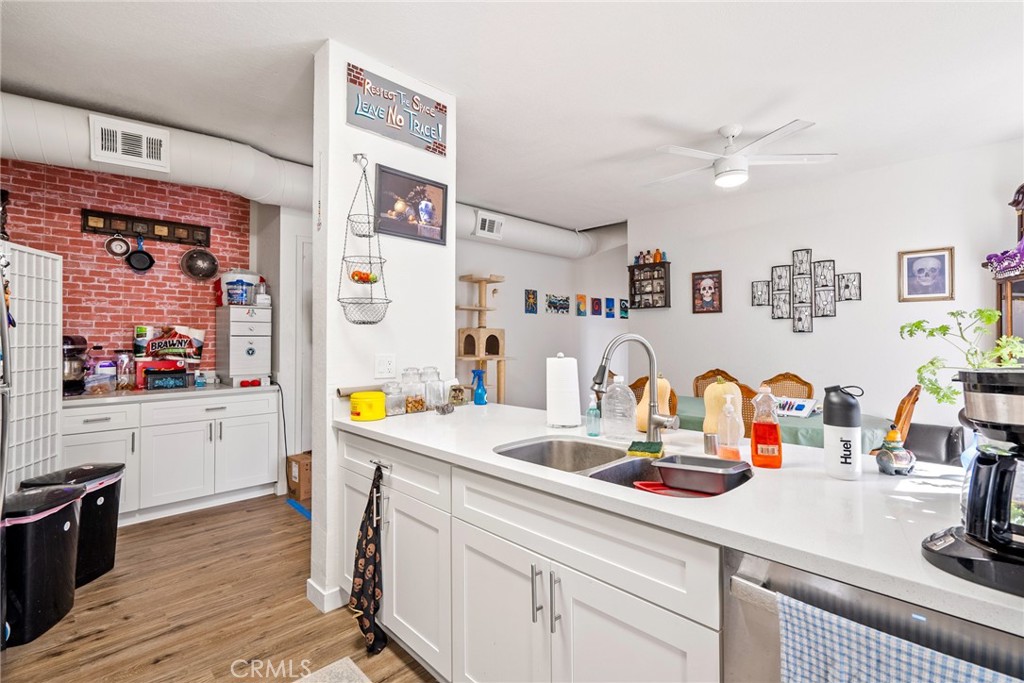 6865 Morro Road, Unit A Atascadero, CA 93422 - Photo 12 of 38 a kitchen with stainless steel appliances a stove a sink and wooden floor