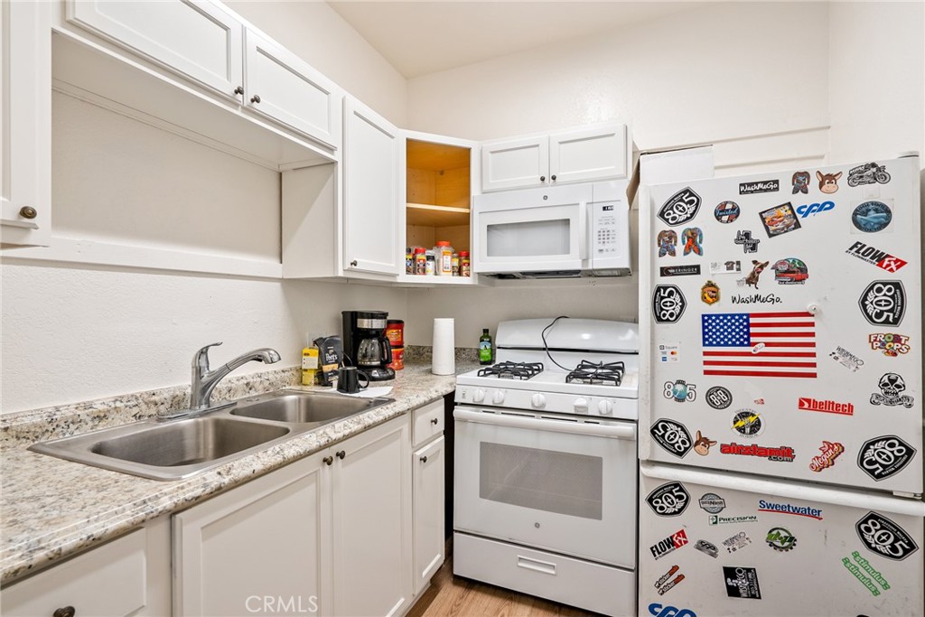 6865 Morro Road, Unit A Atascadero, CA 93422 - Photo 24 of 38 a kitchen with stainless steel appliances a sink a stove and a microwave