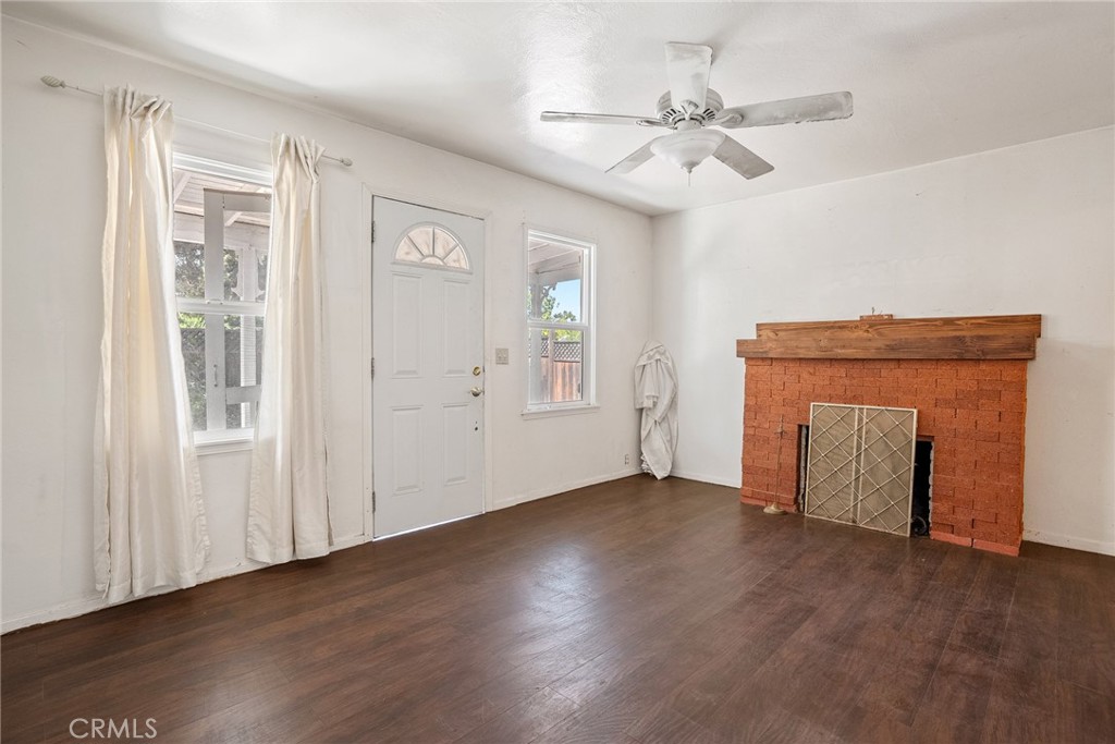 6865 Morro Road, Unit A Atascadero, CA 93422 - Photo 31 of 38 an empty room with wooden floor chandelier fan and windows