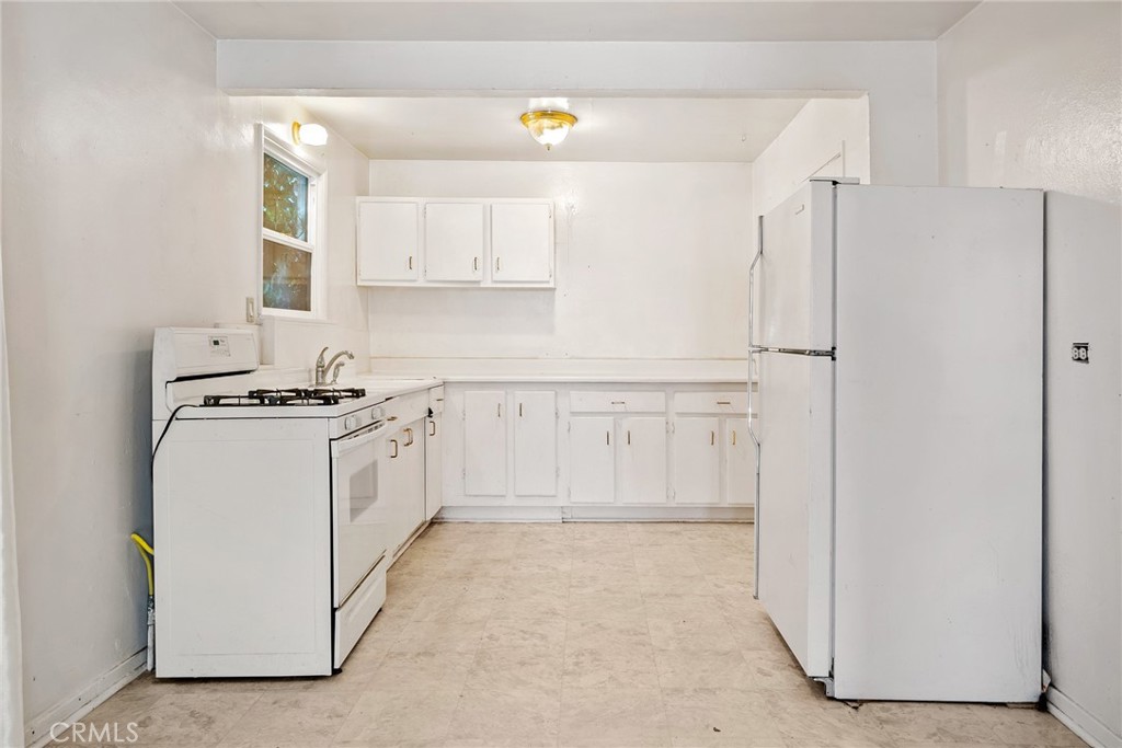 6865 Morro Road, Unit A Atascadero, CA 93422 - Photo 33 of 38 a kitchen with white cabinets and white appliances