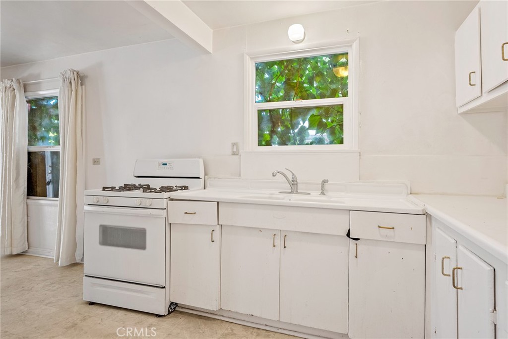 6865 Morro Road, Unit A Atascadero, CA 93422 - Photo 34 of 38 a kitchen with white cabinets appliances and sink