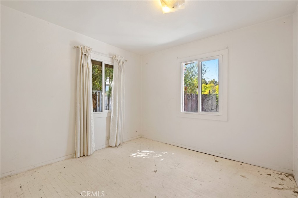 6865 Morro Road, Unit A Atascadero, CA 93422 - Photo 37 of 38 an empty room with a window and wooden floor