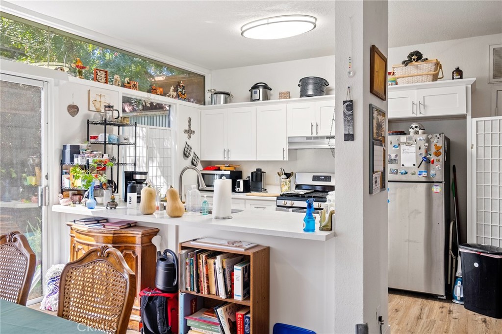 6865 Morro Road, Unit A Atascadero, CA 93422 - Photo 9 of 38 a kitchen with stainless steel appliances a refrigerator and a wooden floor