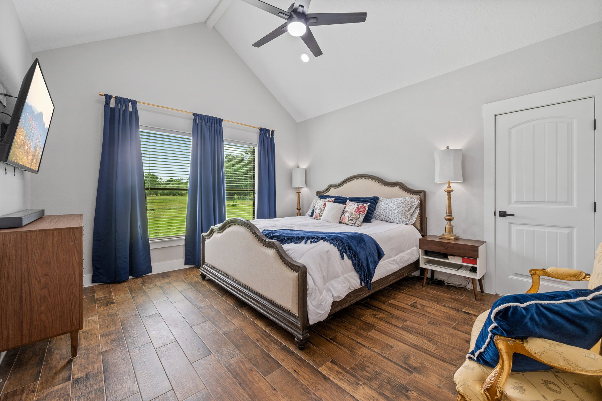 356 Barrow-White Road Anahuac, TX 77514 - Photo 17 of 30 a bedroom with a bed and wooden floor