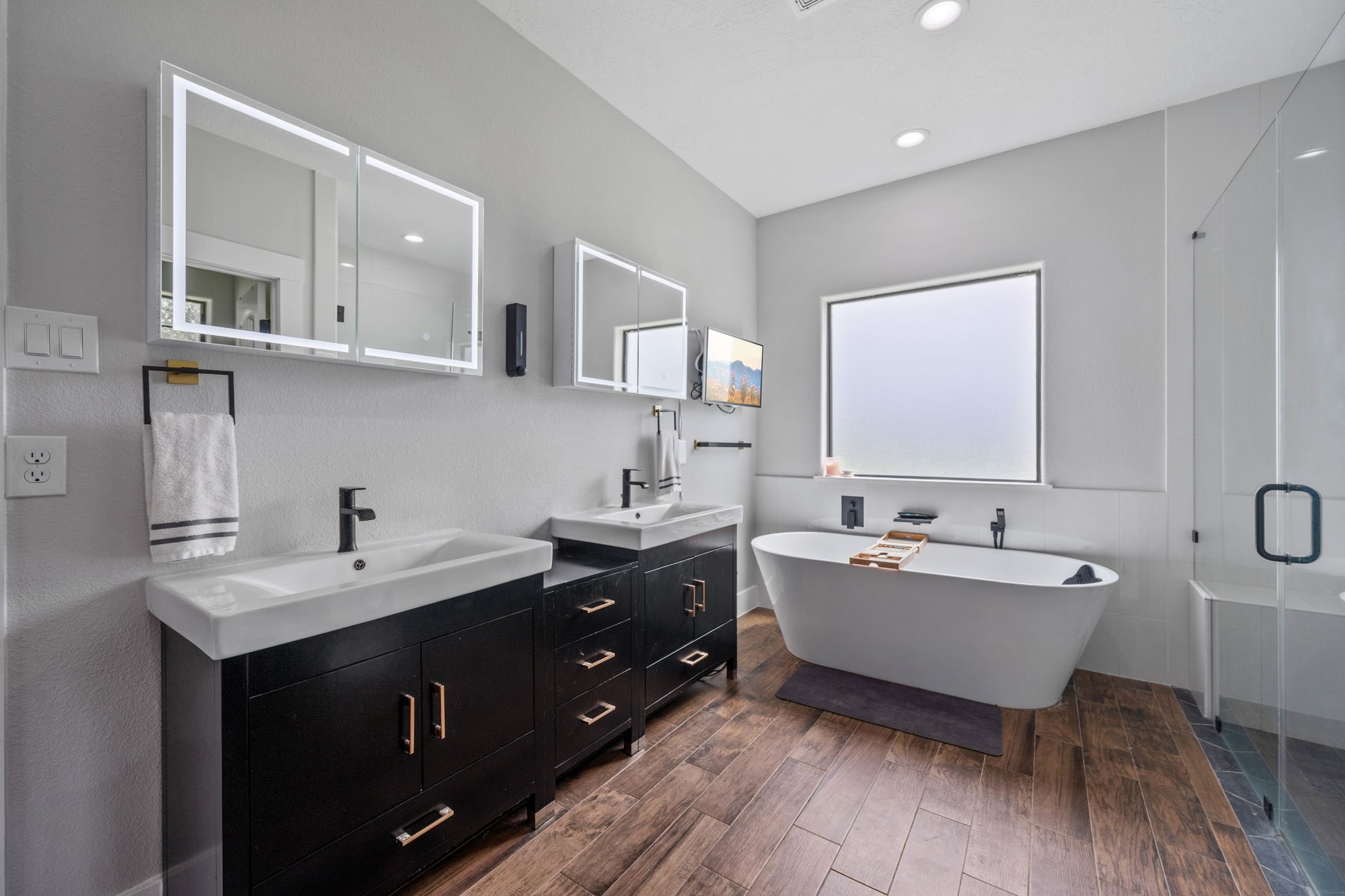 356 Barrow-White Road Anahuac, TX 77514 - Photo 19 of 30 a bathroom with a double vanity sink mirror and bathtub