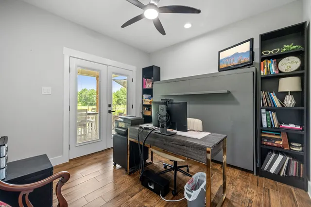 a workspace with furniture bookshelf and a window