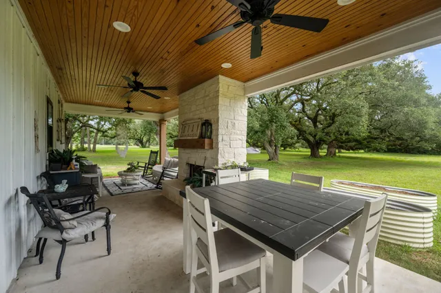 a view of a patio with a table chairs and a backyard