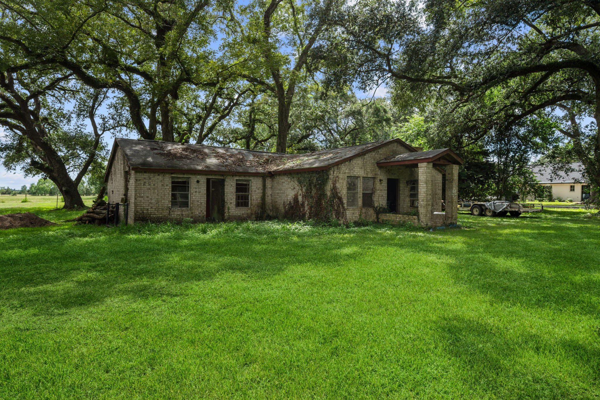 356 Barrow-White Road Anahuac, TX 77514 - Photo 30 of 30 a front view of house with a garden and porch