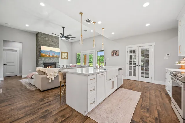 a large white kitchen with a large window