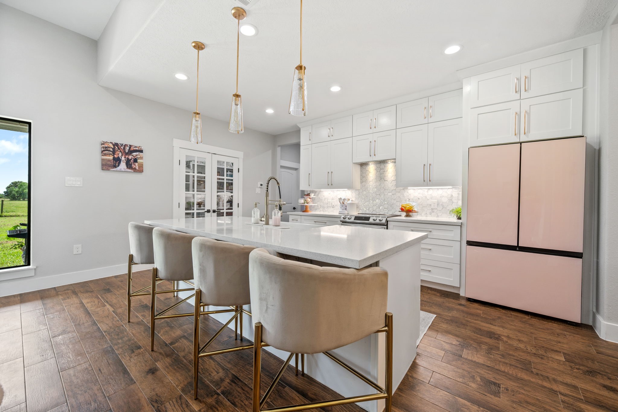 356 Barrow-White Road Anahuac, TX 77514 - Photo 8 of 30 a kitchen with stainless steel appliances granite countertop a refrigerator a sink a stove a dining table and chairs