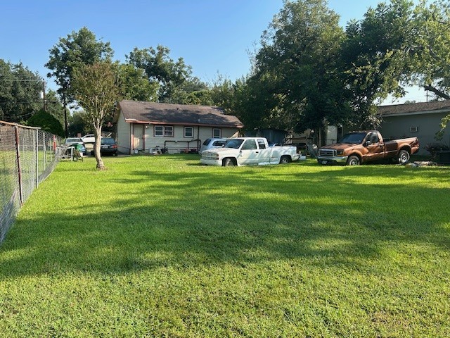 715 West Rittenhouse Street Houston, TX 77091 - Photo 4 of 6 a front view of a house with a garden and trees