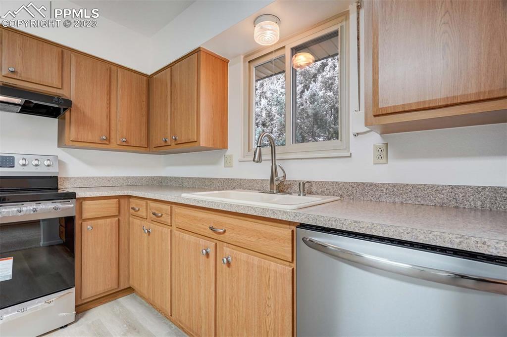 7228 River Bend Road Colorado Springs, CO 80911 - Photo 12 of 48 a kitchen with appliances cabinets and a sink