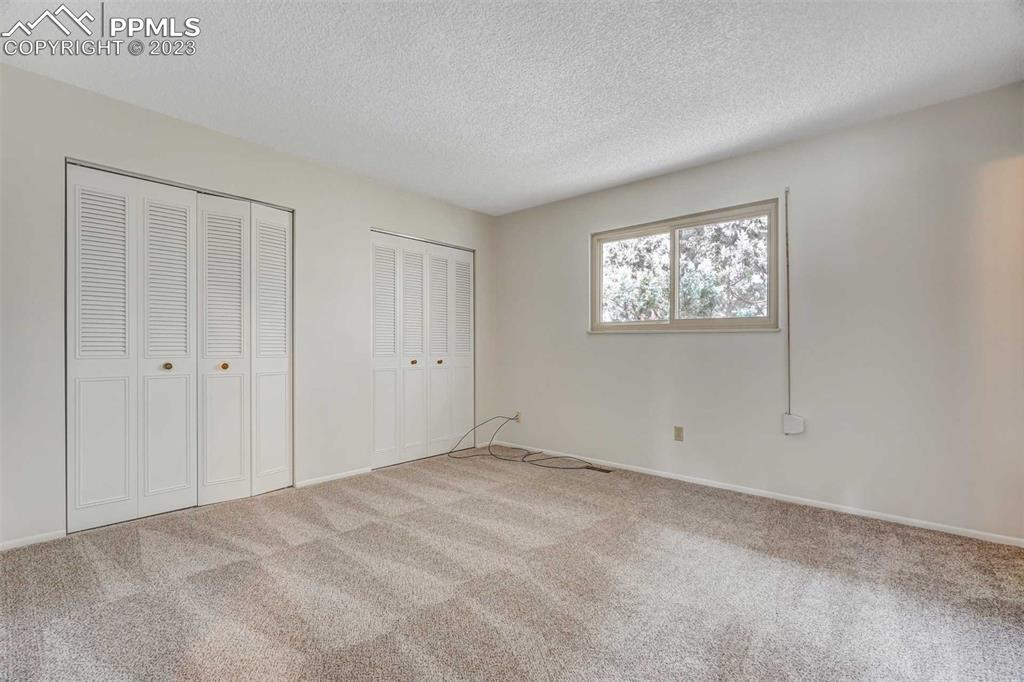 7228 River Bend Road Colorado Springs, CO 80911 - Photo 15 of 48 a view of an empty room with windows