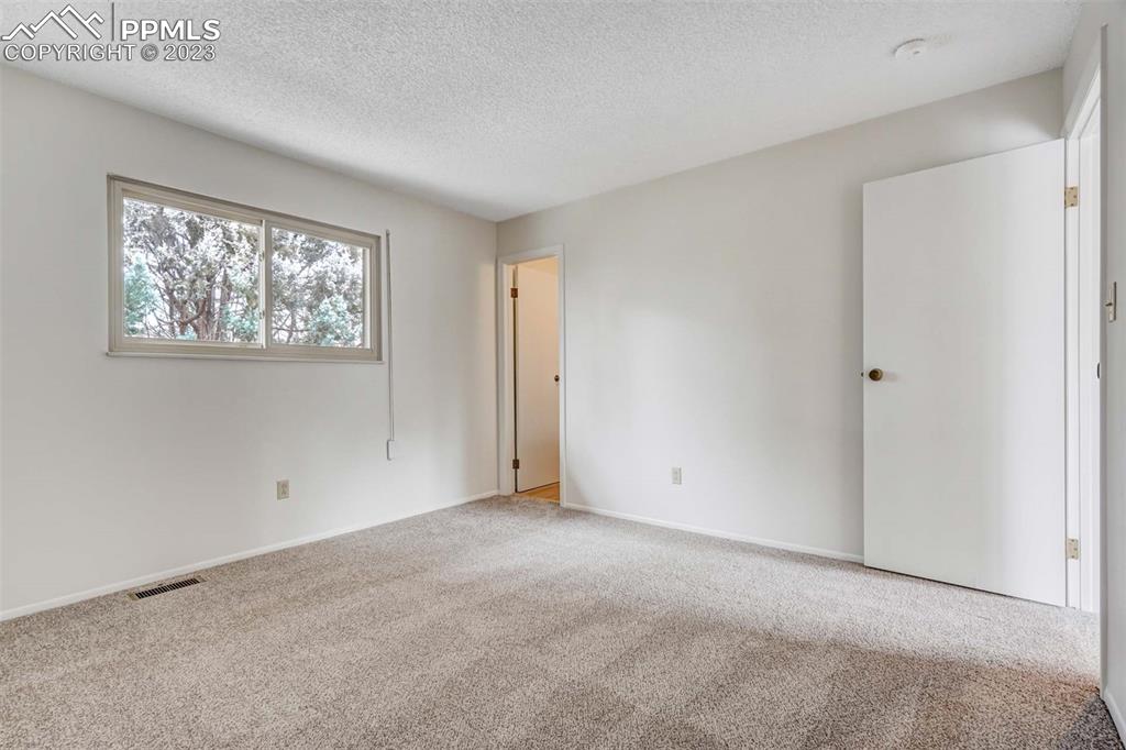 7228 River Bend Road Colorado Springs, CO 80911 - Photo 16 of 48 a view of an empty room with windows