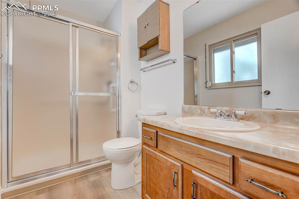 7228 River Bend Road Colorado Springs, CO 80911 - Photo 18 of 48 a bathroom with a granite countertop sink toilet and shower