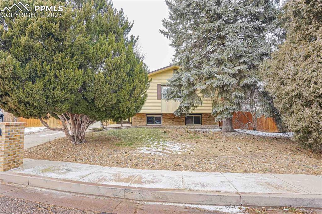 7228 River Bend Road Colorado Springs, CO 80911 - Photo 2 of 48 front view of a house with a trees