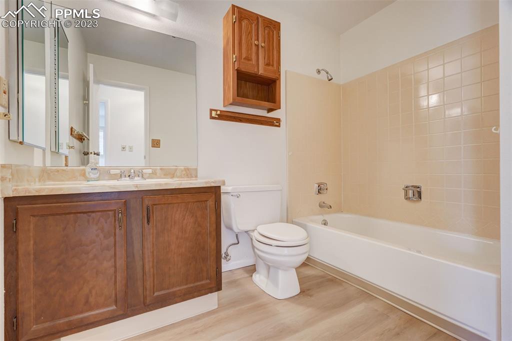 7228 River Bend Road Colorado Springs, CO 80911 - Photo 25 of 48 a bathroom with a sink toilet a mirror and bathtub