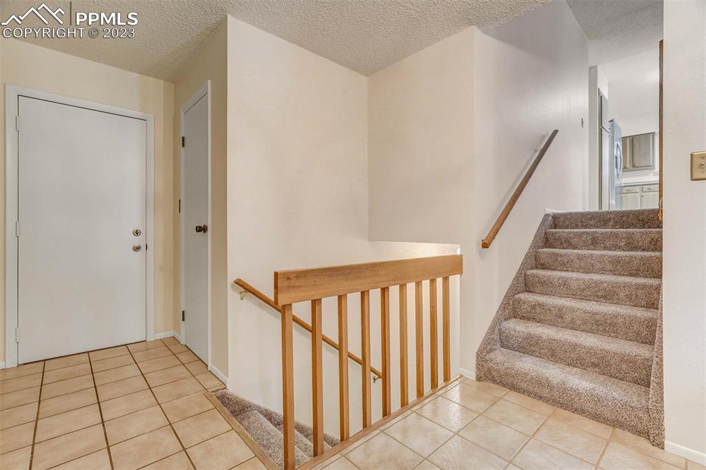 7228 River Bend Road Colorado Springs, CO 80911 - Photo 26 of 48 a view of an entryway with staircase