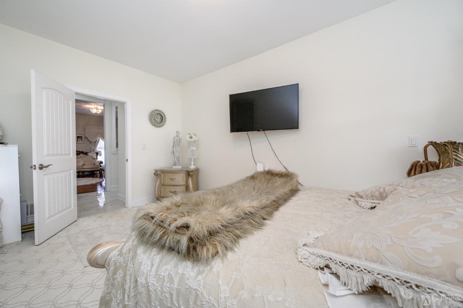 36 Shurts Road Asbury, NJ 08802 - Photo 21 of 56 a bedroom with a bed and a flat screen tv