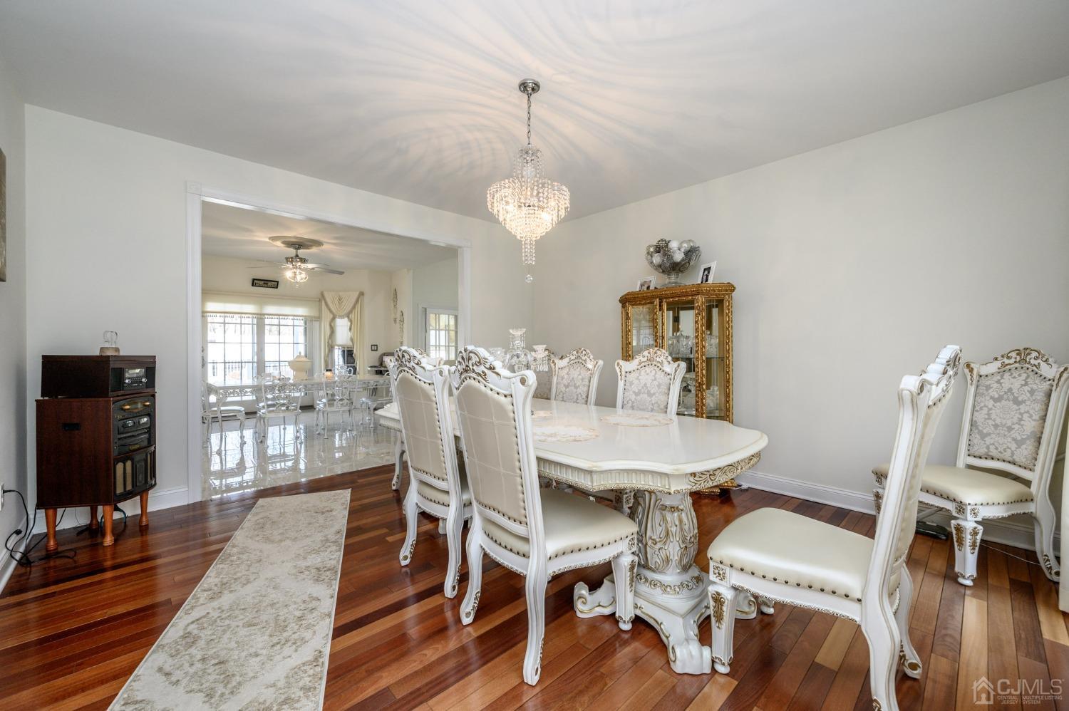 36 Shurts Road Asbury, NJ 08802 - Photo 9 of 56 a dining room with wooden floor a chandelier a wooden table and chairs
