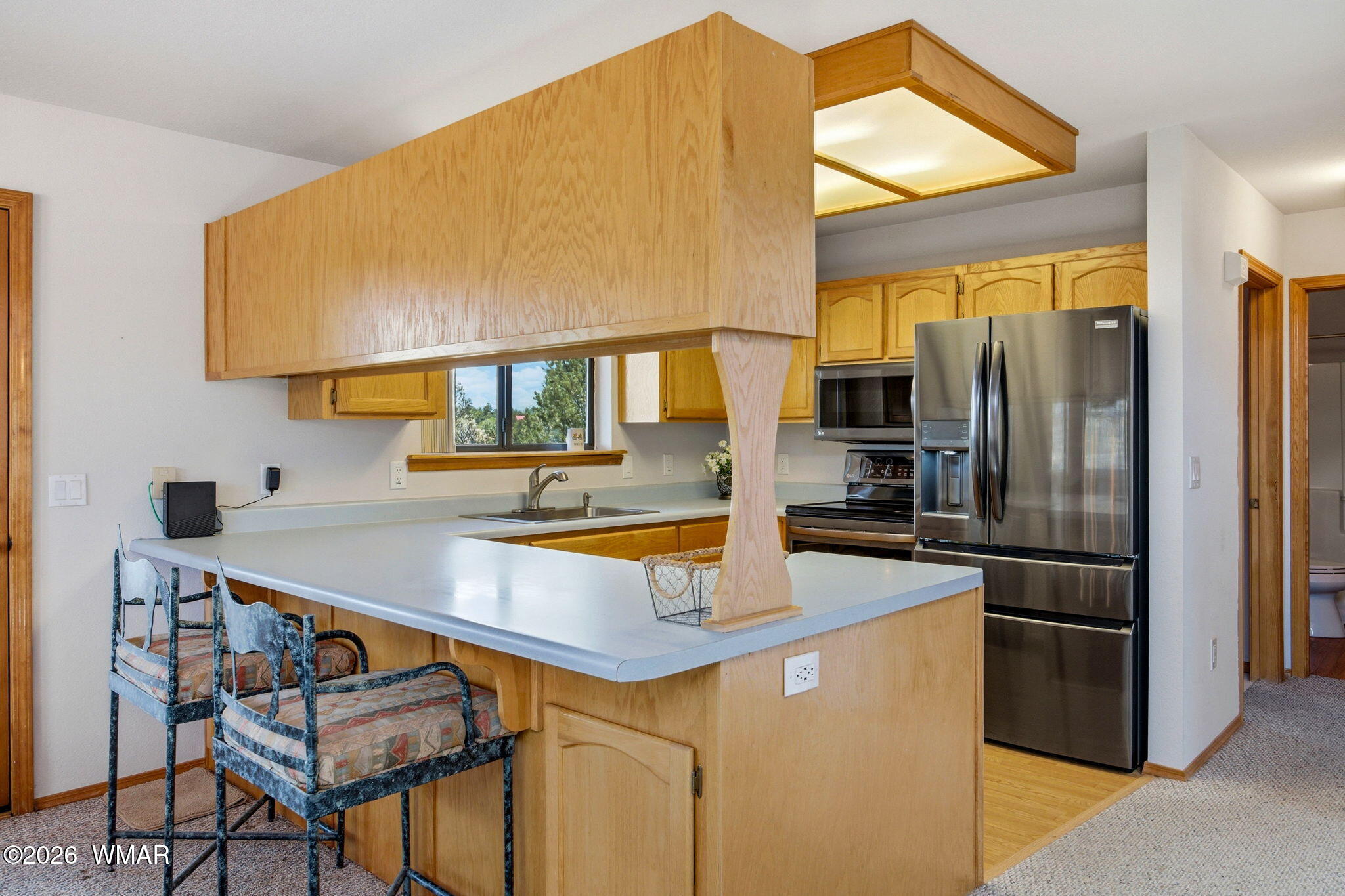 2806 Sky Hawk Drive Overgaard, AZ 85933 - Photo 14 of 43 a kitchen with stainless steel appliances a sink and a refrigerator