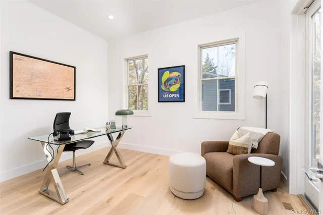 a living room with furniture a rug and a window