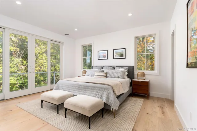 a bedroom with a bed and a large window