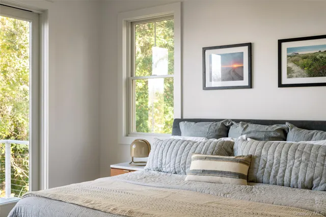 a bedroom with furniture and a window