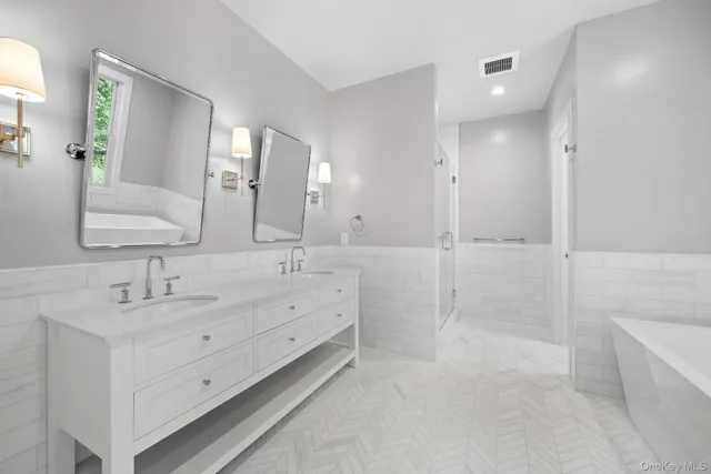 a bathroom with a double vanity sink mirror double and shower