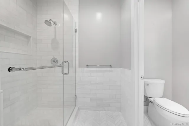 a white toilet sitting next to a bathroom sink