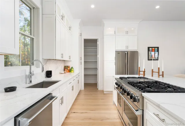 a kitchen with a sink stove and refrigerator