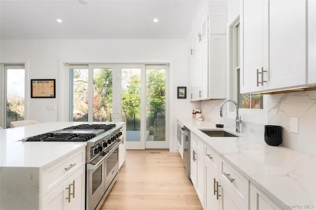 a kitchen with stainless steel appliances a stove sink and cabinets