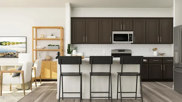 a kitchen with stainless steel appliances a stove a microwave a sink and cabinets