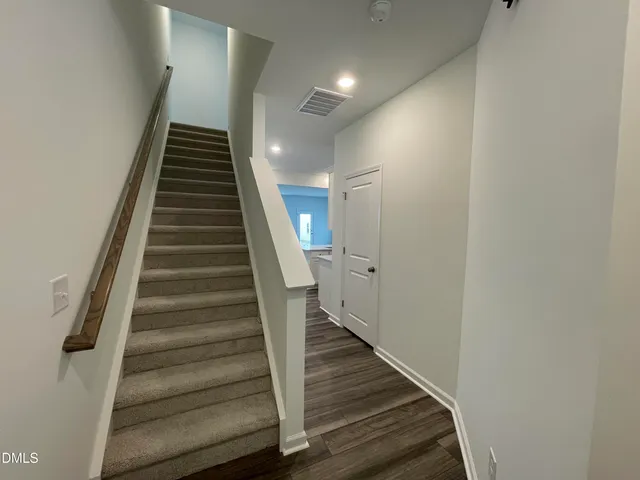a view of entryway and hall with wooden floor