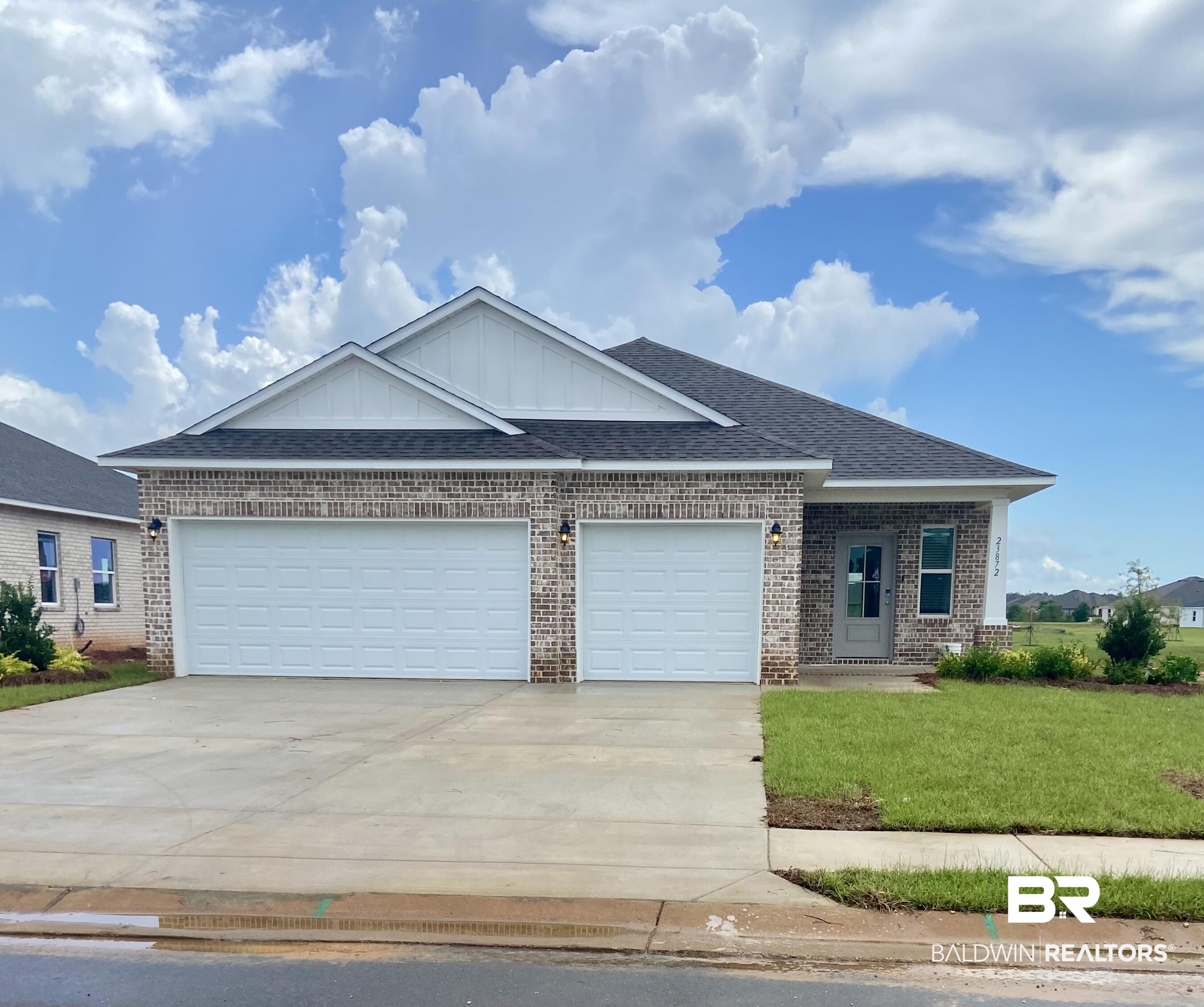 23872 Dominus Drive Daphne, AL 36526 - Photo 1 of 1 View of front facade featuring a garage and a front yard