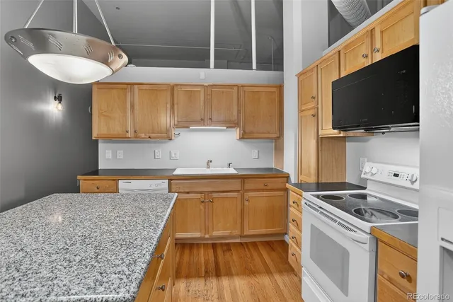 a kitchen with a sink a stove and a microwave