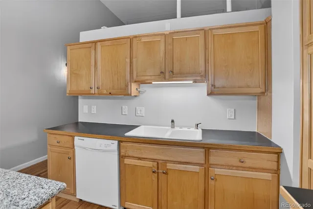 a kitchen with stainless steel appliances granite countertop a sink and a cabinets