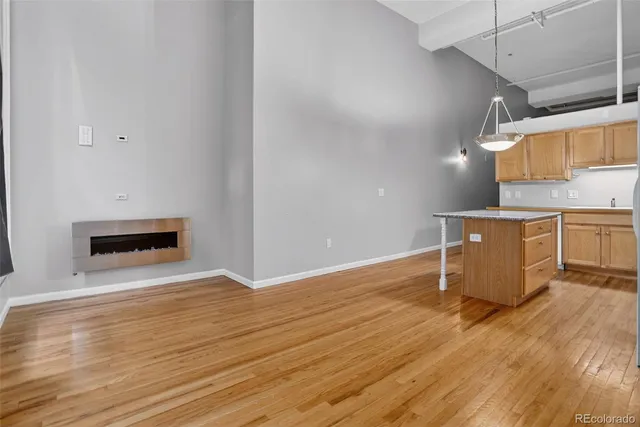 a view of a kitchen with wooden floor and electronic appliances